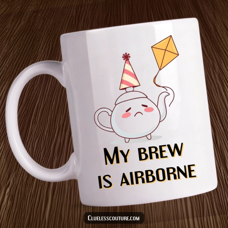 Funny mug featuring a confused teapot in a party hat struggling to fly a kite, symbolizing quirky determination and humorous struggles.
