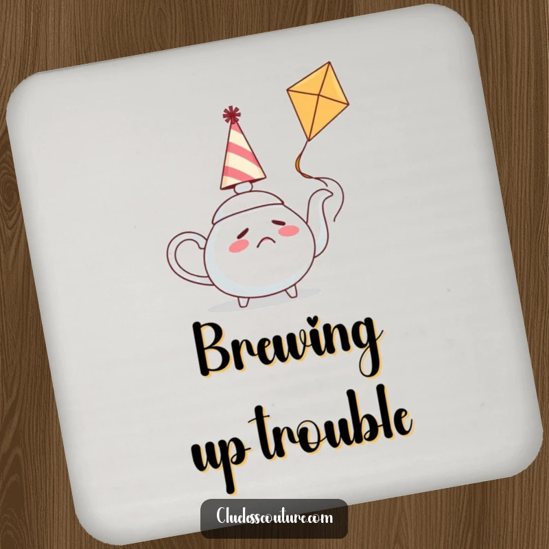 Funny drink coaster featuring a confused teapot wearing a party hat attempting to fly a kite, protecting surfaces with humor.