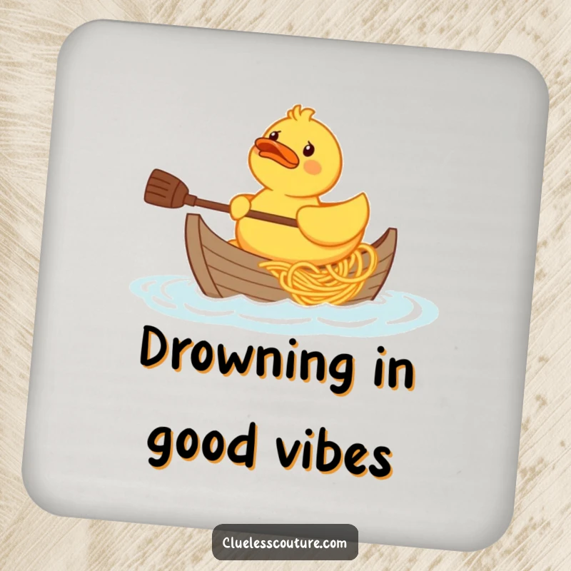Funny confused rubber duck character trying to paddle a boat made of spaghetti, printed on a protective drink coaster.