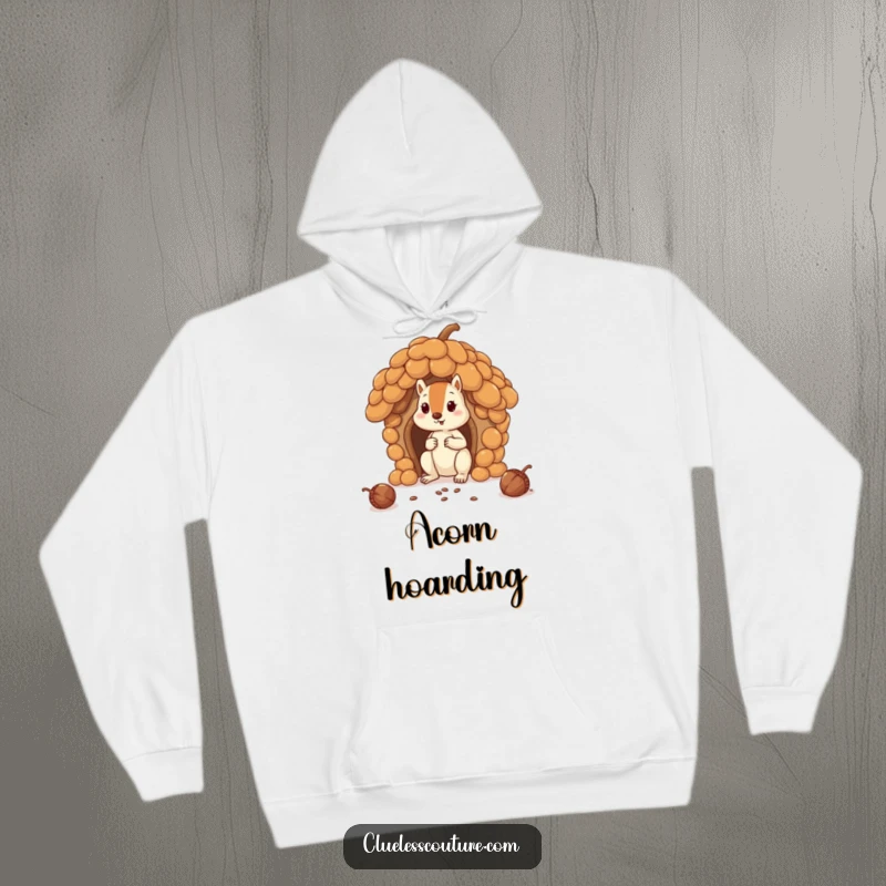 Funny squirrel hilariously attempting to build a house with oversized acorns, on a warm hoodie, ideal for a funny gift.