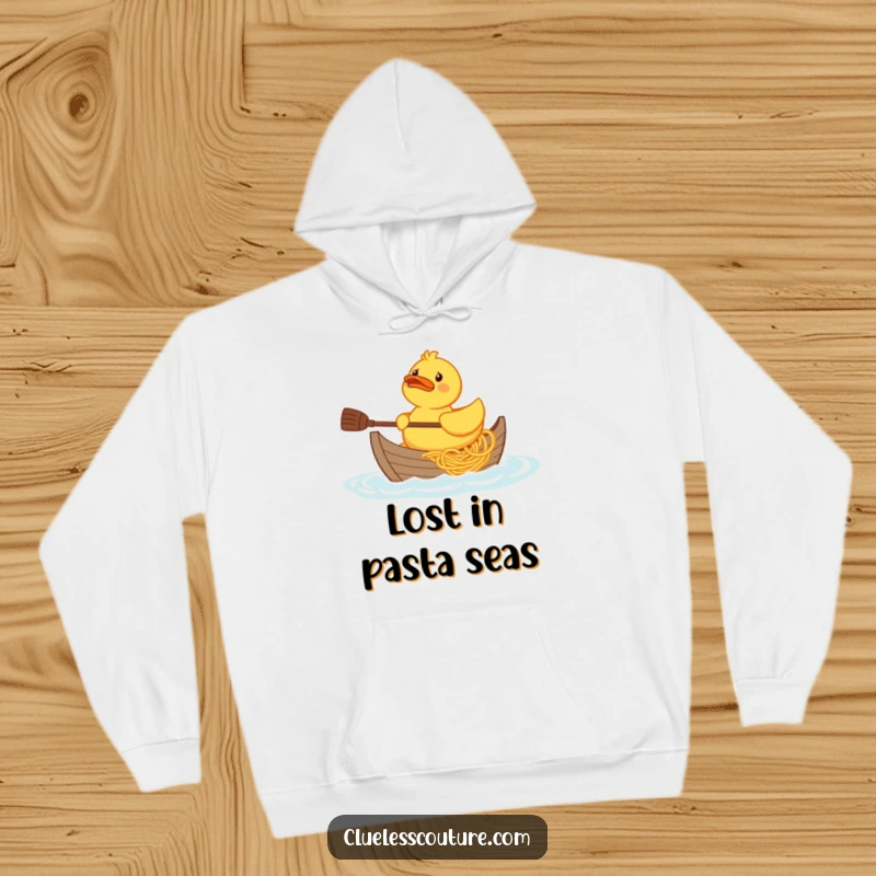 Funny confused rubber duck character trying to paddle a boat made of spaghetti, graphic on a cozy hoodie.