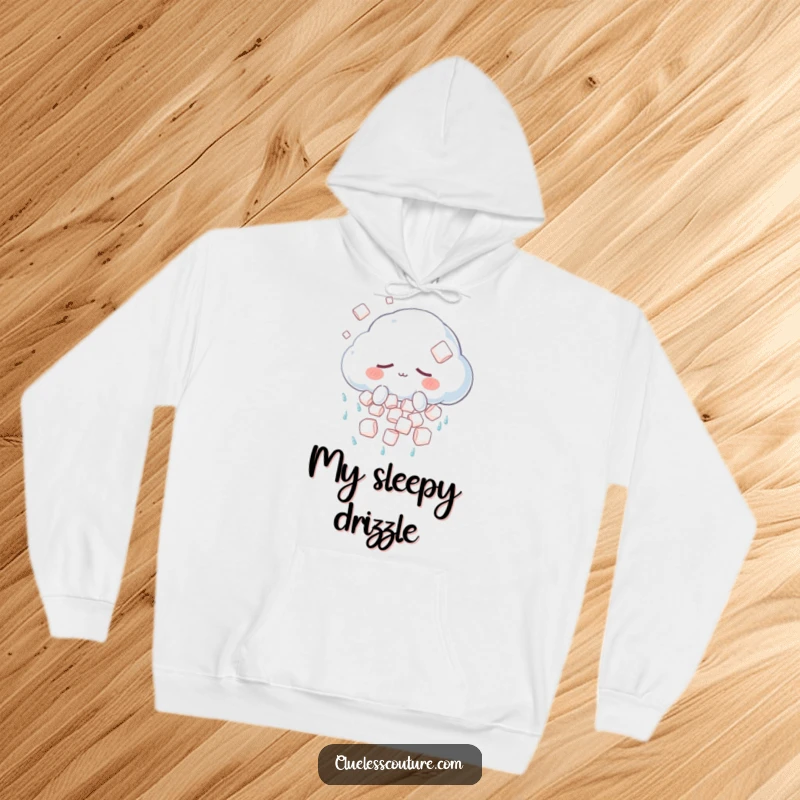 Funny hoodie featuring a sleepy anthropomorphic cloud character unintentionally showering fluffy marshmallows, creating a dreamlike, sweet scene.