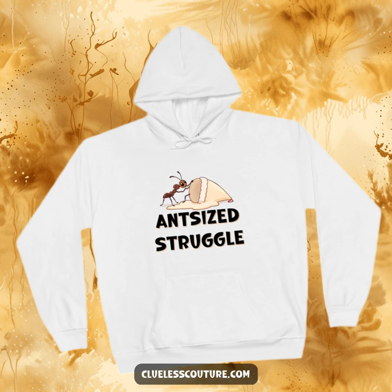 Funny hoodie showcasing a determined ant making a monumental effort to lift a gigantic dropped ice cream cone, implying strength and humor.