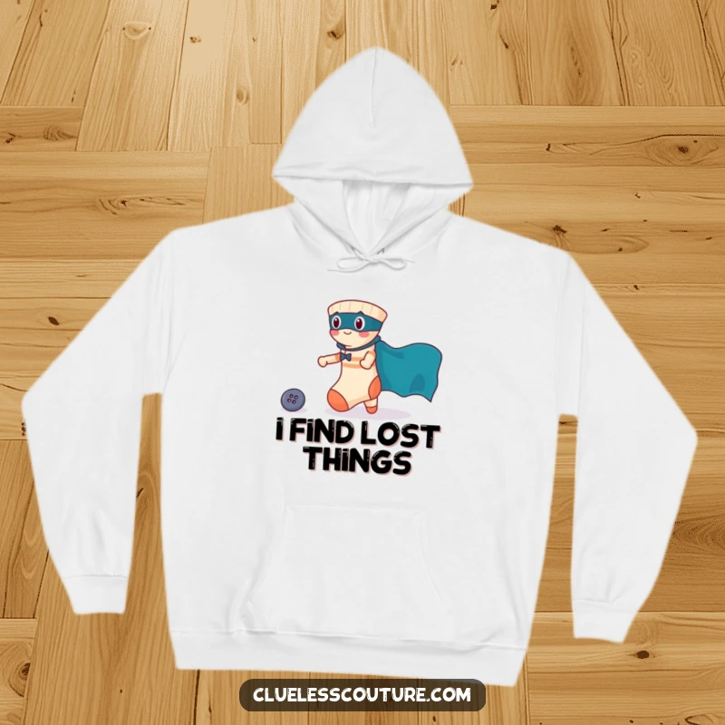 Funny hoodie featuring a brave sock with a superhero cape heroically rescuing a lost button, offering warmth and courage.