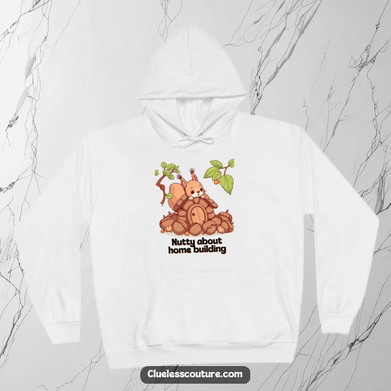 Funny hoodie with a squirrel trying to construct a dwelling from giant acorns, illustrating a scene of endearing, slightly absurd, effort.