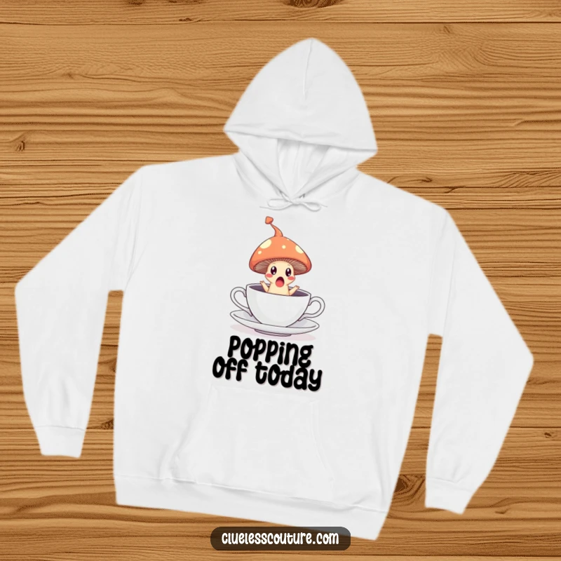 Funny hoodie depicting a surprised mushroom leaping from a teacup, leaving a steam trail, cozy and magical.