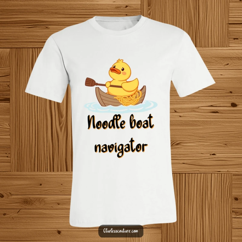Funny confused rubber duck character trying to paddle a boat made of spaghetti, printed on a t-shirt.