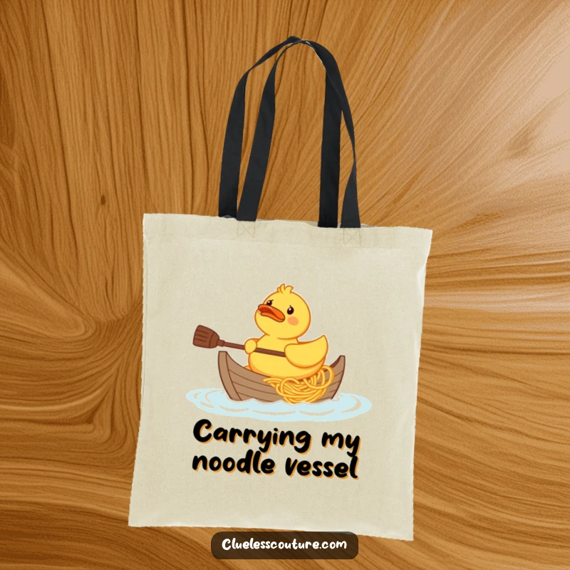 Funny confused rubber duck character trying to paddle a boat made of spaghetti, printed on a durable tote bag.