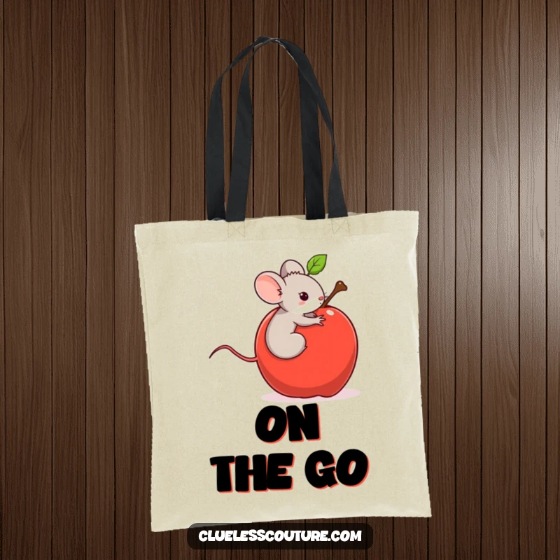 Funny tote bag with a tiny mouse riding a runaway rolling apple, a charming and humorous image for carrying everyday items.